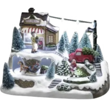 Decoratieve kerstscène met figuren, huis, kerstbomen en verlichting