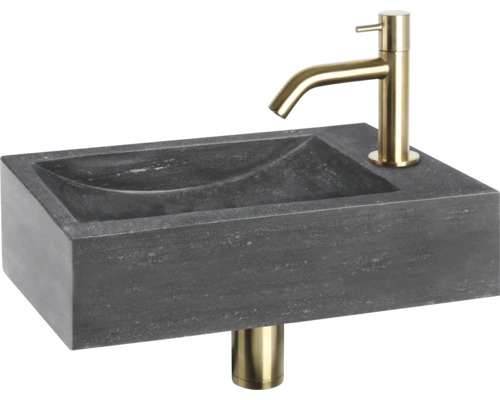 Wastafel van steen met gouden kraan