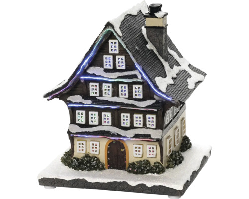 Decoratief, verlicht miniatuurhuis met sneeuw voor kerstdecoratie