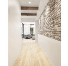 Hal met houten balken, bakstenen muur en houten vloer