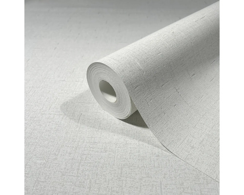 Rol wit behang met lichte structuur.