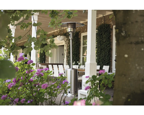 Terras met terrasverwarmer, tafel en stoelen in de tuin