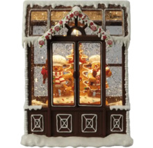 Decoratief peperkoekhuis met peperkoekmannetjes en sneeuw als kerstdecoratie