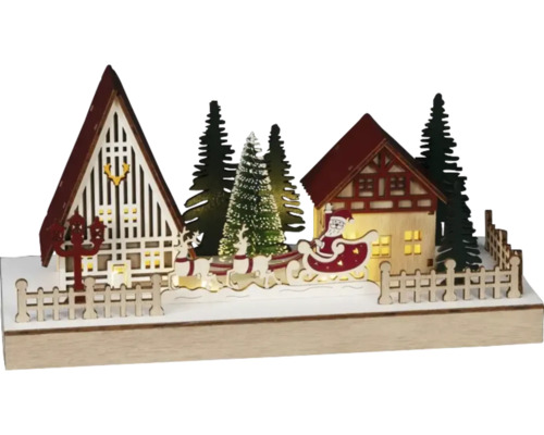 Decoratief kerstlandschap met huizen, kerstbomen, rendieren en de kerstman in een slee