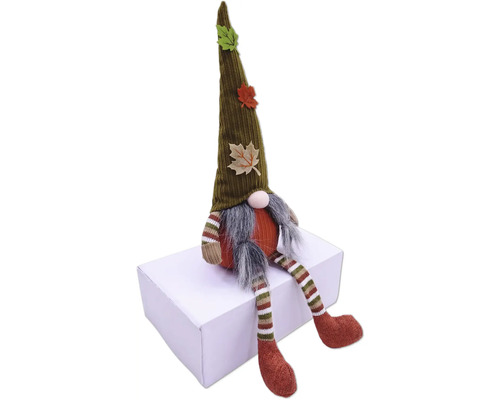 Decoratieve kabouter met muts en herfstbladeren zit op een doos