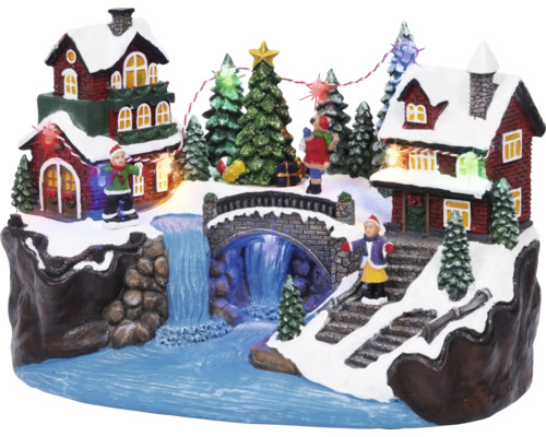 Kerstdecoratie met huizen, brug, waterval, bomen en figuren