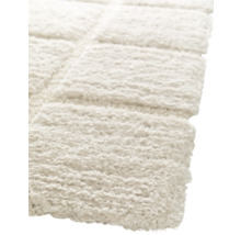 Detailopname van een lichtgekleurd, rechthoekig vloerkleed