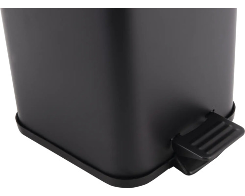 Detailopname van een zwarte afvalemmer met voetpedaal.