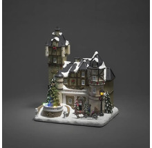 Decoratief kersttafereel met verlicht kasteel, figuren en paardenslee.