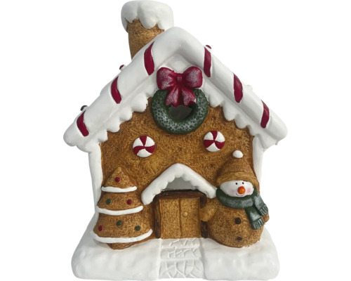 Decoratie van een peperkoekhuis met kerstboom en sneeuwpop