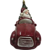 Decoratief kerstmanfiguur in auto met kerstboom