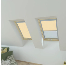 Twee dakramen met rolgordijnen in een lichte zolderkamer