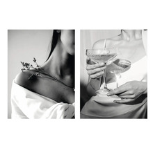 Zwart-witafbeelding van een vrouw met een bloem op haar schouder en een vrouw die een glas vasthoudt