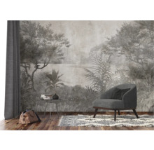 Scène met een fauteuil, een tafel met boeken en een tas voor een wandbekleding met jungle motief.