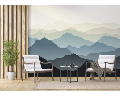 Woonkamer met behang van een berglandschap, twee stoelen en een kleine tafel.