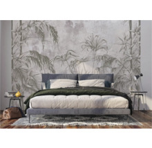 Slaapkamer met junglebehang achter het bed