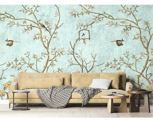 Woonkamer met behang met vogel- en bloemmotief, bank en bijzettafels.