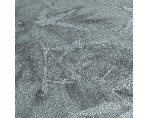 Close-up van een gestructureerd textielbehang met plantenmotief