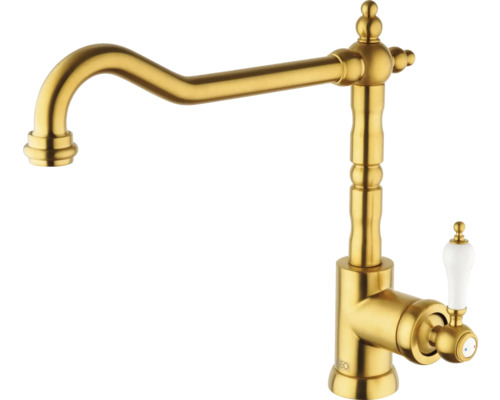 Goudkleurige keukenkraan met klassiek design en witte hendel