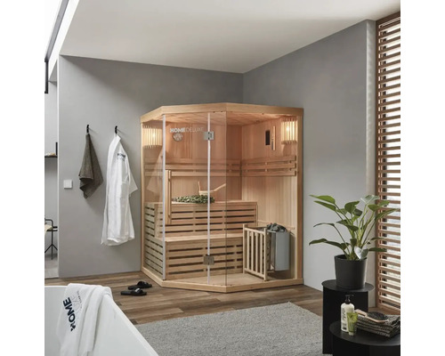 Hoeksauna met glazen voorkant, banken en saunakachel in een badkamer