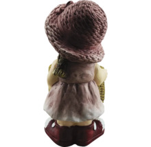 Tuinbeeld meisje met hoed en mand van achteren