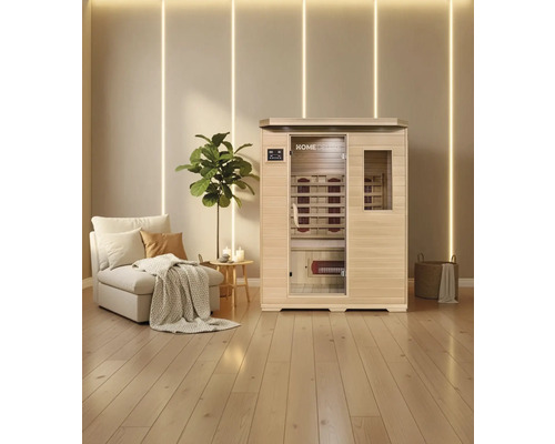 Infraroodsauna met zitbank en infraroodlampen in een lichte kamer met houten vloer