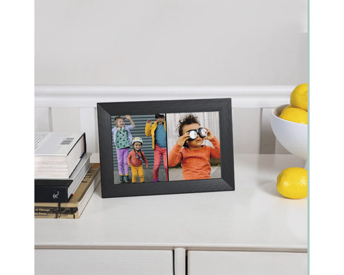 Zwarte digitale fotolijst met foto's van kinderen op een tafel met boeken en citroenen.