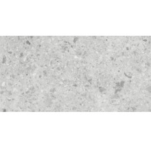 Close-up van een vloertegel met terrazzo-look.