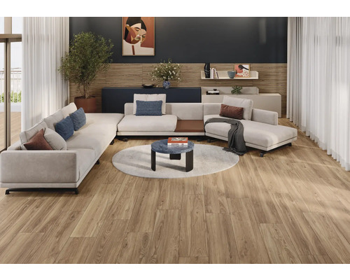 Woonkamer met hoekbank, salontafel op een rond tapijt en houten vloer