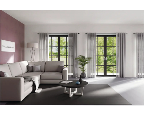 Woonkamer met hoekbank, salontafel en gordijnen voor ramen