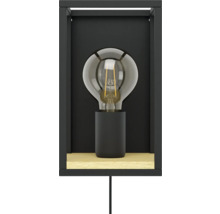 Wandlamp met gloeilamp in een zwart frame