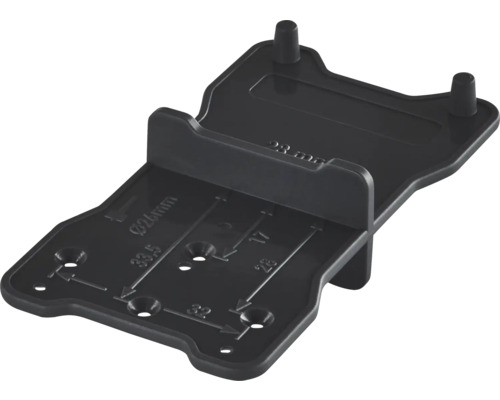 Zwarte kunststof boormal en aftekensjabloon voor meubelmontage met millimeter-aanduidingen.