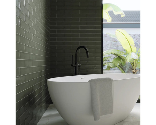 Moderne badkamer met groene tegels, vrijstaand bad en zwarte kraan