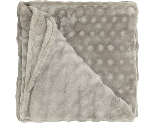 Gevouwen, zachte woondeken met noppenstructuur van polyester.