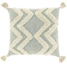 Sierkussen met getuft zigzagpatroon en kwastjes aan de hoeken.