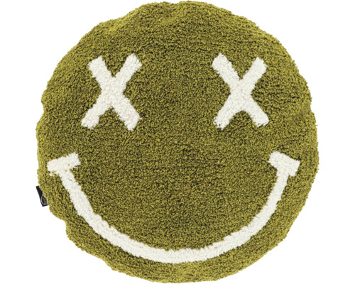 Rond sierkussen van groen, pluizig materiaal met een wit smileygezicht en kruisjes als ogen.