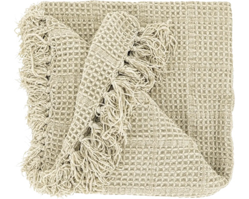 Beige woondeken met wafelstructuur en franjes.