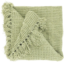Groene plaid met wafelstructuur en franjes.