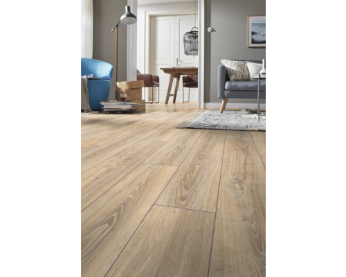 Laminaatvloer met eikenlook in een lichte, modern ingerichte woonkamer met bank en eethoek.
