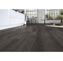 Donkere laminaatvloer met houtlook in een moderne, lichte ruimte met kookeiland en groot raam.