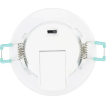 Achteraanzicht van een ronde witte LED-inbouwspot met twee bevestigingsveren en een schakelaar.