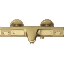Grohe thermostatische badkraan in goud met gekartelde handgrepen, baduitloop en temperatuurbeveiliging op 38 graden Celsius.