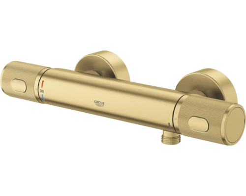 Grohe douchethermostaat in goud met gekartelde grepen, cilindrisch design en temperatuurinstelling op 38 graden.