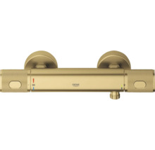 Grohe douchethermostaat in goudlook met getextureerde grepen en temperatuurweergave 38 graden.