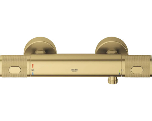 Grohe douchethermostaat in goudlook met getextureerde grepen en temperatuurweergave 38 graden.