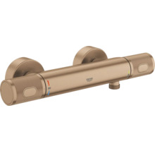 Grohe thermostaat douchekraan voor wandmontage, geborsteld brons, gekartelde grepen, Grohe Logo en temperatuurbegrenzing bij 38 graden.