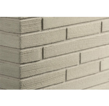 Gestructureerde steenstrips in baksteenlook op een hoek met horizontale groeven.