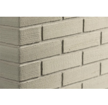 Steenstrips met baksteenlook en fijn gestructureerd oppervlak aan een muurhoek.