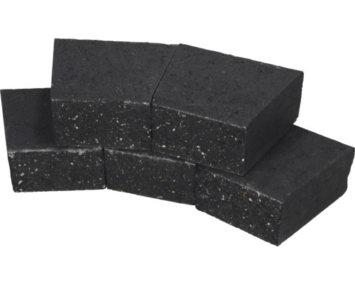 Antracietkleurige trapeziumvormige betonnen klinkers voor het aanleggen van cirkelvormige paden in de tuin.