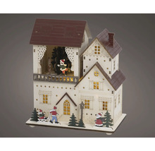Kerstdecoratie van hout, verlicht huis met schaatsers, de kerstman en kerstbomen.